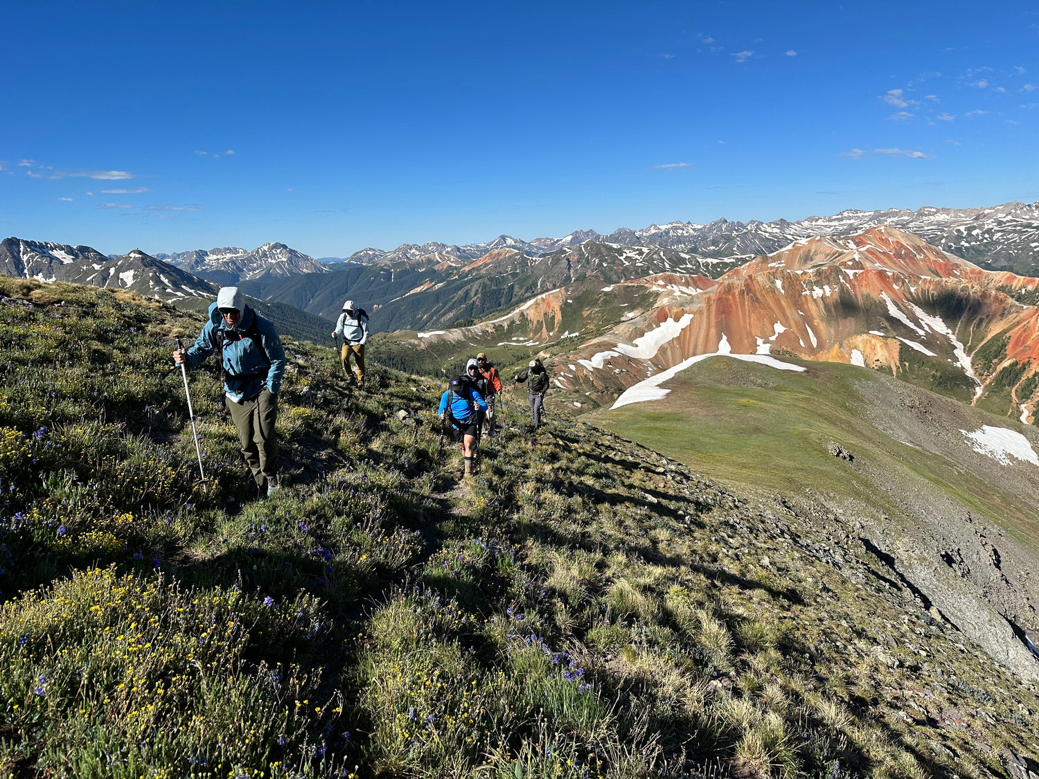 six people hiking in the mountains